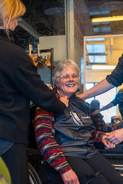 A person in a wheelchair smiling AI-generated content may be incorrect.