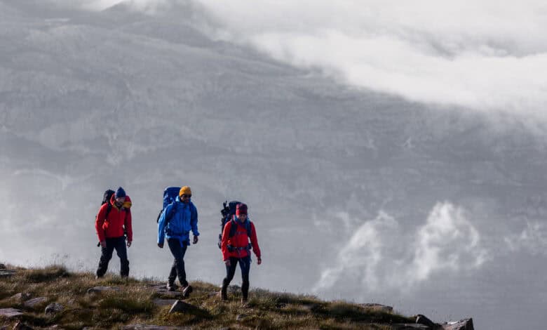 Bright outdoor hiking adventure with backpacks in rugged landscape, ideal for outdoor enthusiasts and nature lovers.