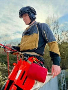 High-visibility outdoor rescue gear with helmet, harness, and safety equipment suitable for search and rescue missions.