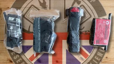 First aid kit components in sealed packaging on wooden surface with outdoor rescue logo.