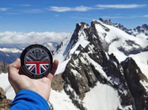 1. Durable outdoor rescue badge with British flag and mountain design.