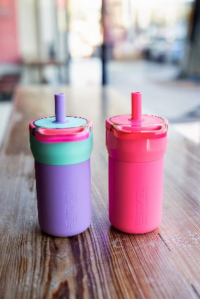 A couple of sippy cups on a table AI-generated content may be incorrect.