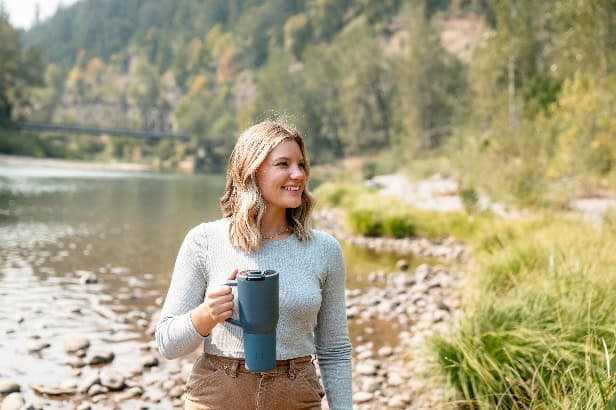 A person holding a blue mug AI-generated content may be incorrect.