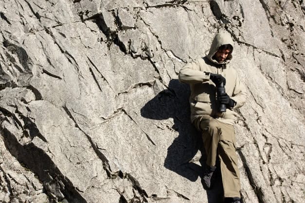 A person sitting on a rock AI-generated content may be incorrect.