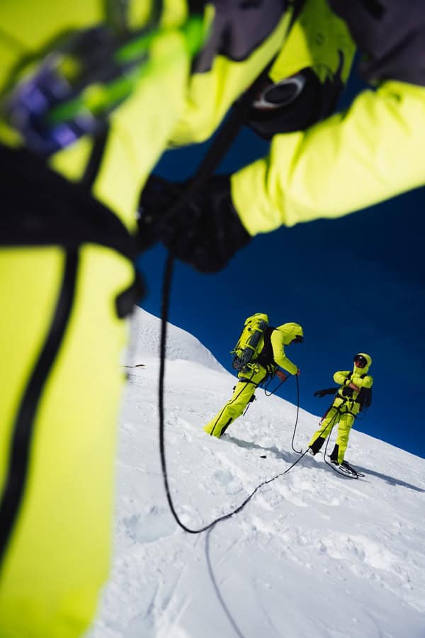 High-visibility winter clothing for safe mountain skiing and outdoor adventures in harsh weather.