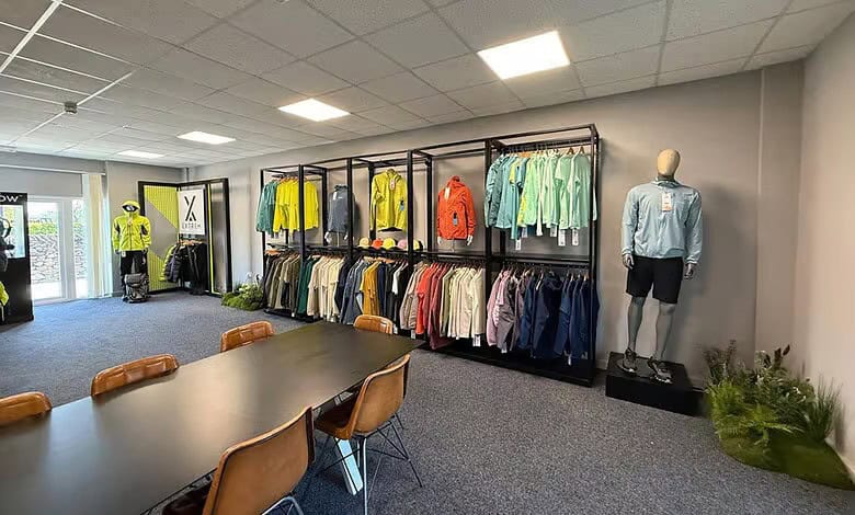 High-quality outdoor and sports apparel display at Outdoor Insight, featuring jackets, fleeces, and activewear.