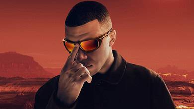 Eclipsed sun over mars landscape with man in sunglasses and black jacket, science and space exploration concept.