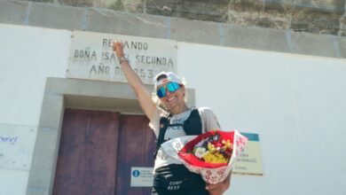 Happy female hiker holding a bouquet of flowers after outdoor adventure or hike.