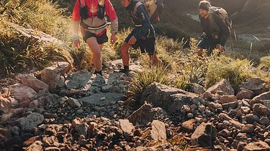 Adventure hiking in mountain terrain with outdoor gear and backpacks.