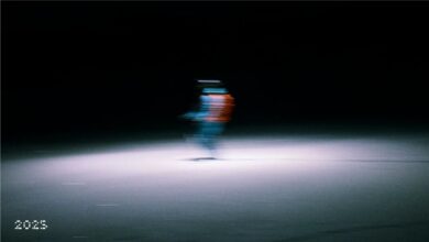 Blurred night-time ice skating figure with colourful lights for outdoor sports and winter activity enthusiasts.