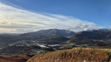 Panoramic view of rolling hills and mountains in a scenic outdoor landscape, ideal for hiking and exploring nature.