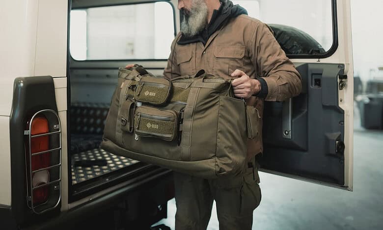 Durable outdoor gear being packed into a vehicle, showcasing hiking and travel equipment for outdoor adventures.