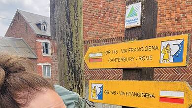 Waymarked trail sign for Camino de Santiago, France to Rome route, outdoor hiking path in UK countryside, pilgrimage trail signage, backpacker adventure photo.
