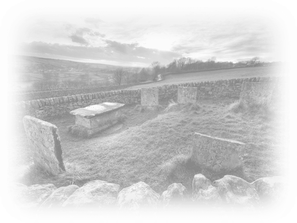 Old historic gravestones in a peaceful outdoor cemetery, rural landscape with stone wall and open sky.