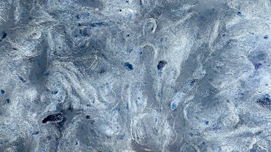 Frozen icy surface with intricate textures and shades of blue, ideal for outdoor winter activities and exploration.