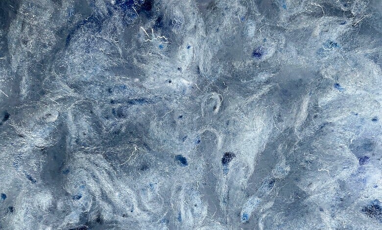 Frozen icy surface with intricate textures and shades of blue, ideal for outdoor winter activities and exploration.