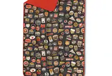 Colourful outdoor camping mattress with patchwork design and red underside, perfect for outdoor adventures.