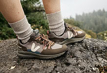 Trail running shoes on rugged outdoor trail in nature, ideal for hiking and adventure sports.