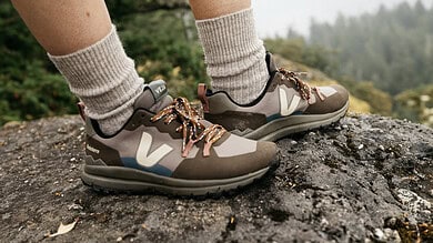 Trail running shoes on rugged outdoor trail in nature, ideal for hiking and adventure sports.