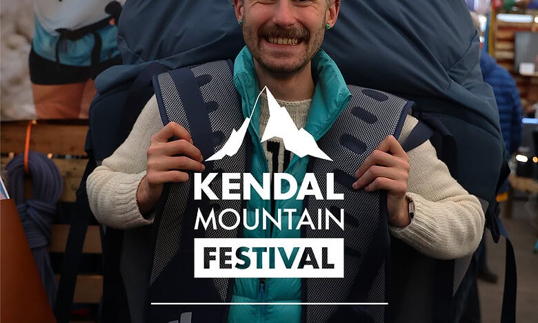 Backpacking enthusiast at Kendal Mountain Festival, showcasing outdoor adventure gear and rugged mountain landscapes.
