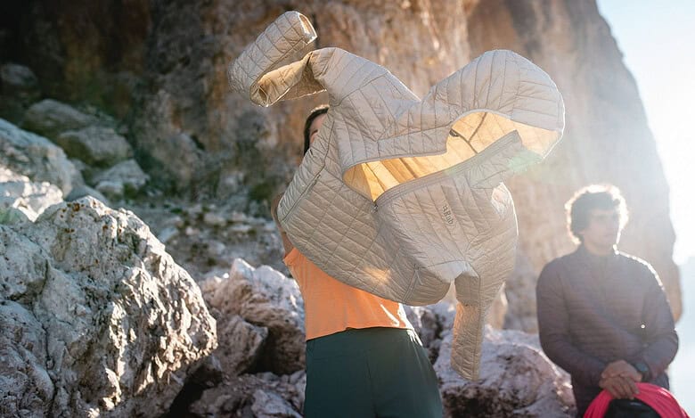 Warm beige insulated outdoor jacket for hiking and nature adventures.
