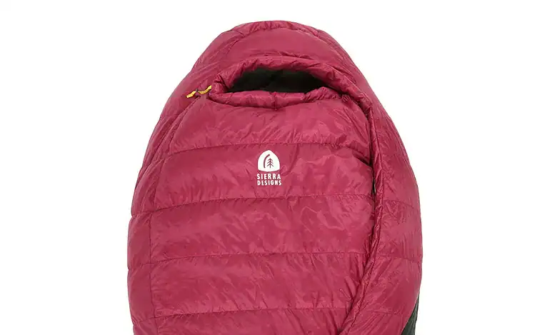 Warm red and black sleeping bag with Sierra Designs logo, ideal for outdoor camping and hiking.