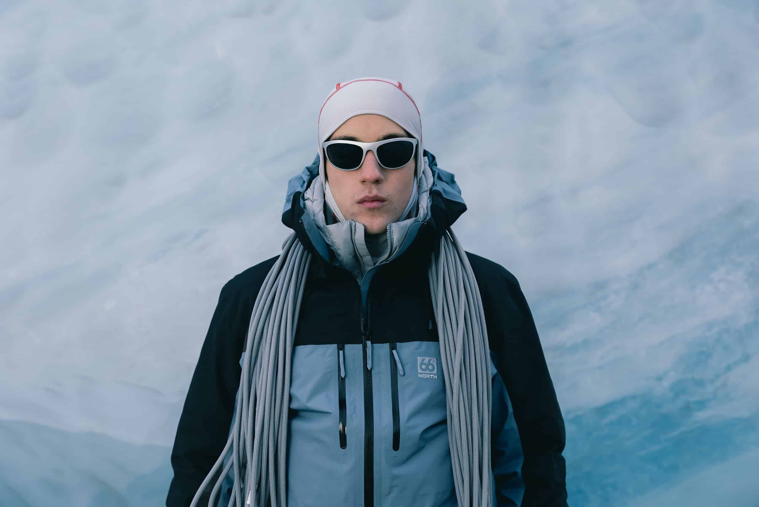Woman in Tindur GORE-TEX Pro jacket and pants in snowy mountain landscape.