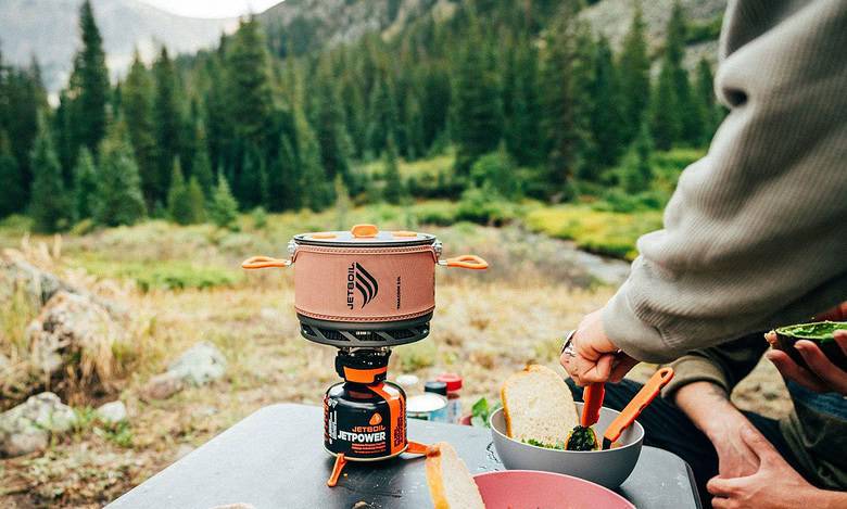 Outdoor Insight portable camping stove with compact design for outdoor cooking.