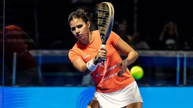 Delfi Brea, top padel player, preparing to hit the ball during a match.
