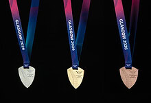 High-quality medals from Glasgow 2026 Winter Sports event with colourful ribbons and metallic finish.