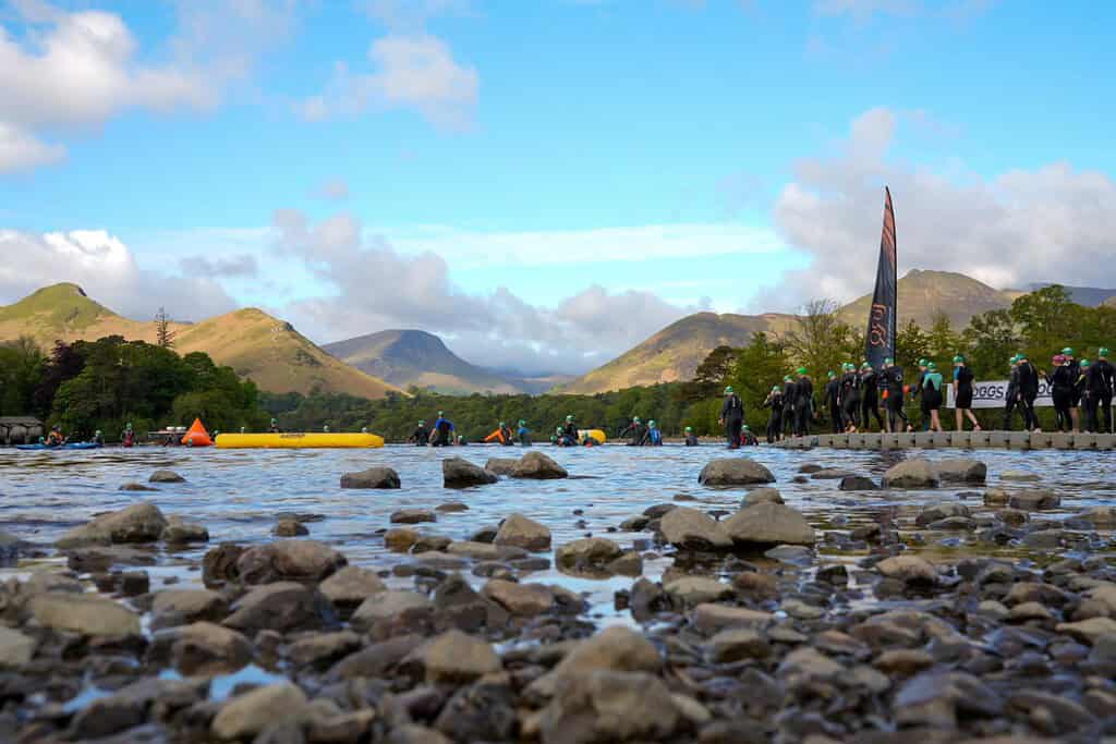 Outdoor water sports scene with kayakers and mountain backdrop in the UK.