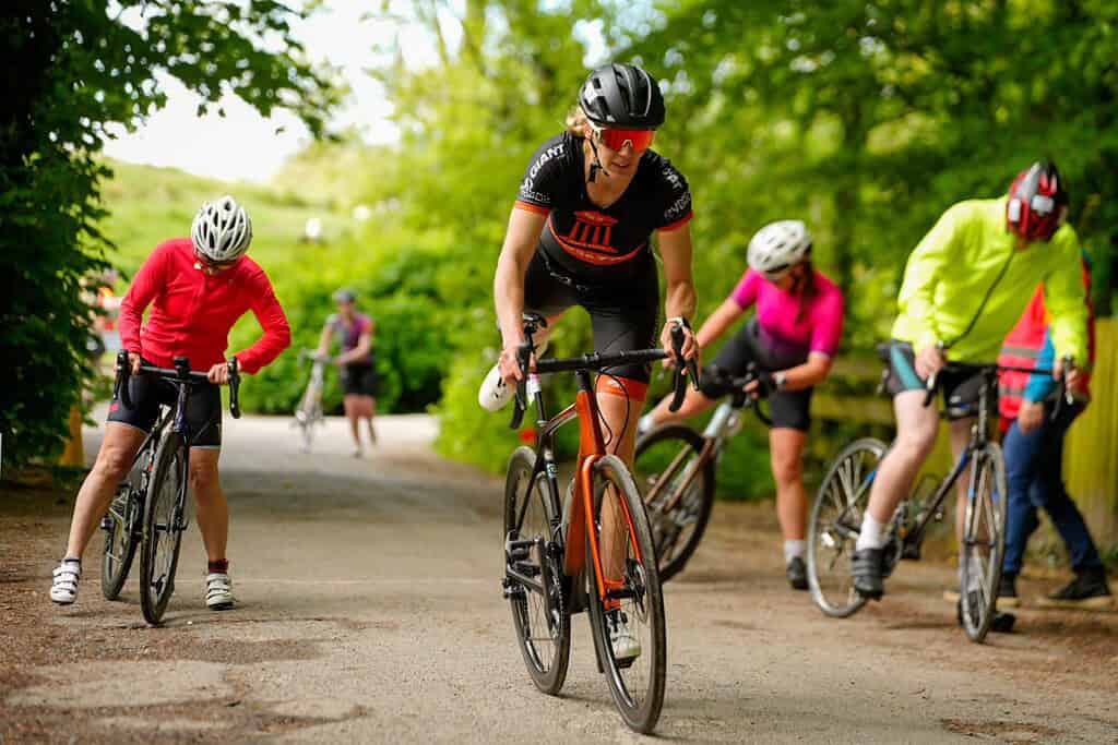 Enjoying a group cycling adventure on a scenic outdoor trail in lush green surroundings.