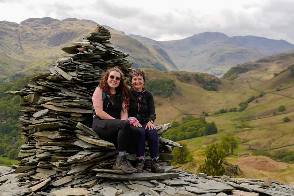 Enjoying outdoor adventure on a scenic hillside with friends in a rugged landscape.