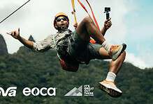 Man kiteboarding outdoors with mountains in background.