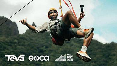 Man kiteboarding outdoors with mountains in background.