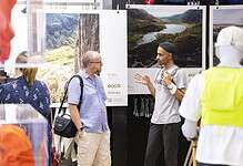 Outdoor Insight booth at an event showcasing nature photography and conservation efforts.